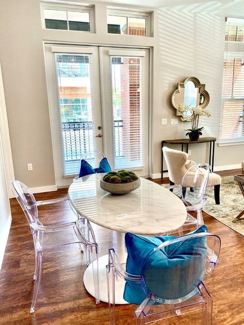 Dining room in front of balcony doorway in Newberry, FL apartment at The Flats at Tioga Town Center